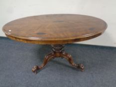 A Victorian walnut oval tilt topped pedestal breakfast table