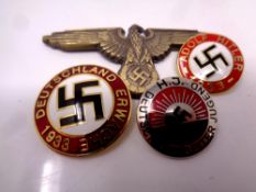 Four German military badges bearing Swastika.