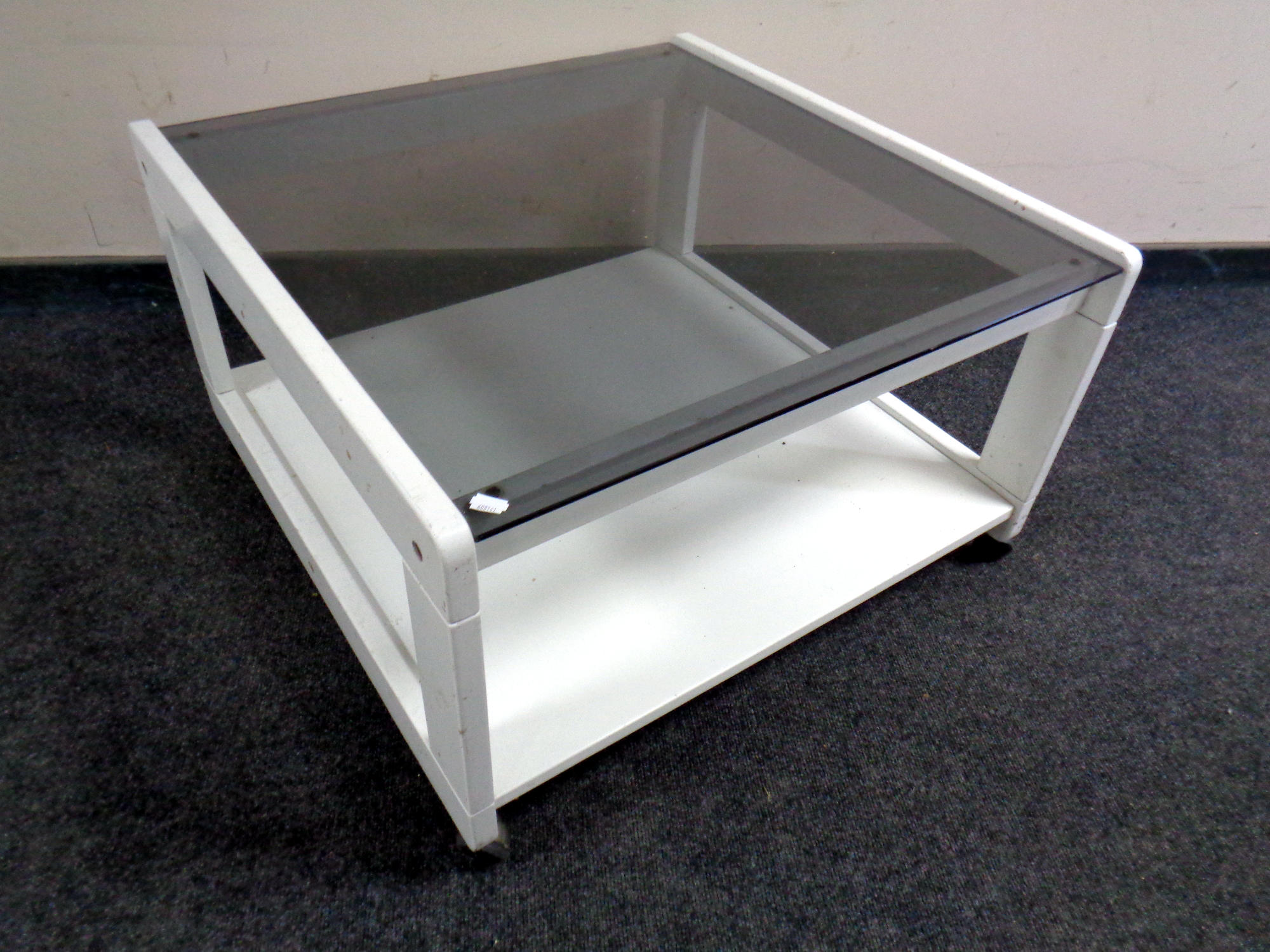 A contemporary coffee table raised on castors