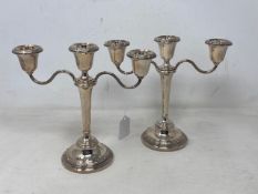 A pair of Lindisfarne silver candelabra, Reid & Sons, Birmingham 1957, height 21.5 cm. (loaded).