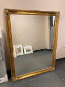 A contemporary gilt framed mirror 4' x 3 '