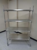 A stainless steel four height catering trolley on castors