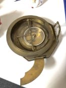 A brass cased calendar compass