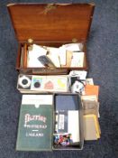 A wooden box containing ephemera, antique postcards,