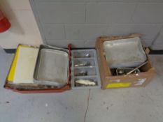 A box and a crate of aluminium kitchen trays, loose cutlery,