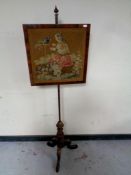 A Victorian rosewood tapestry pole screen