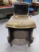 An antique cast iron and brass fire insert