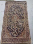 An antique Kashan rug,