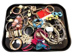 A tray of costume jewellery, beaded necklaces, bangles,