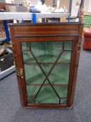 An inlaid mahogany glazed hangining corner cabinet