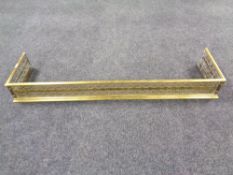 A Victorian brass fret work fender.