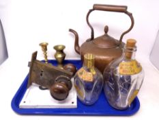 A tray of Victorian copper kettle, Dimple whisky decanters, cast iron plaque,