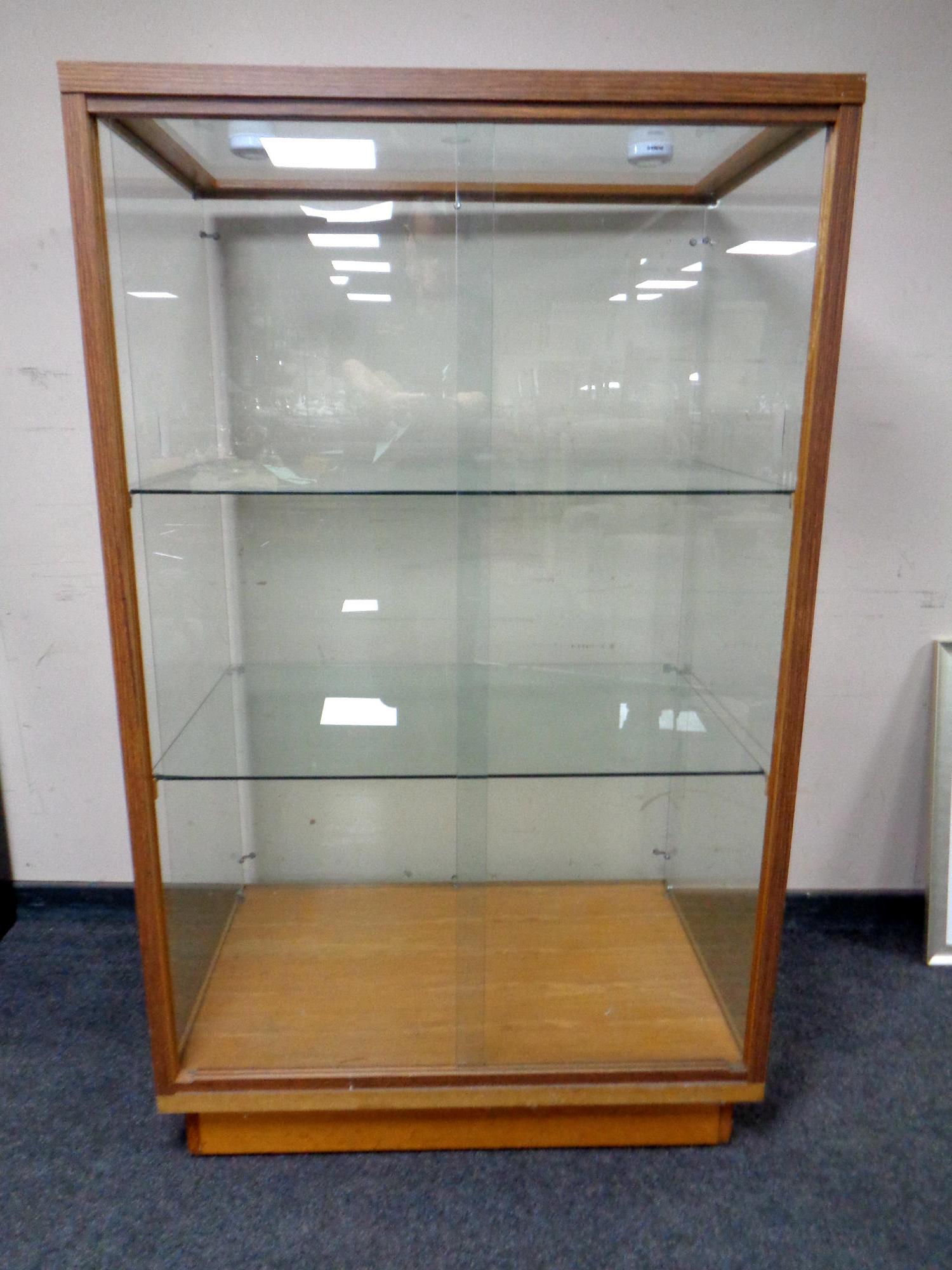 A sliding door shop display cabinet fitted two internal shelves,