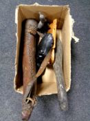 A box of tribal items, carved mask, wooden club,