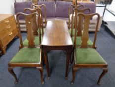A beech drop leaf table and six high back dining chairs