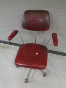 A 20th century swivel chair in red vinyl