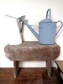 A rustic pine stool together with an enamelled jug and watering can