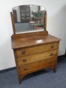 An Edwardian oak three drawer dressing chest