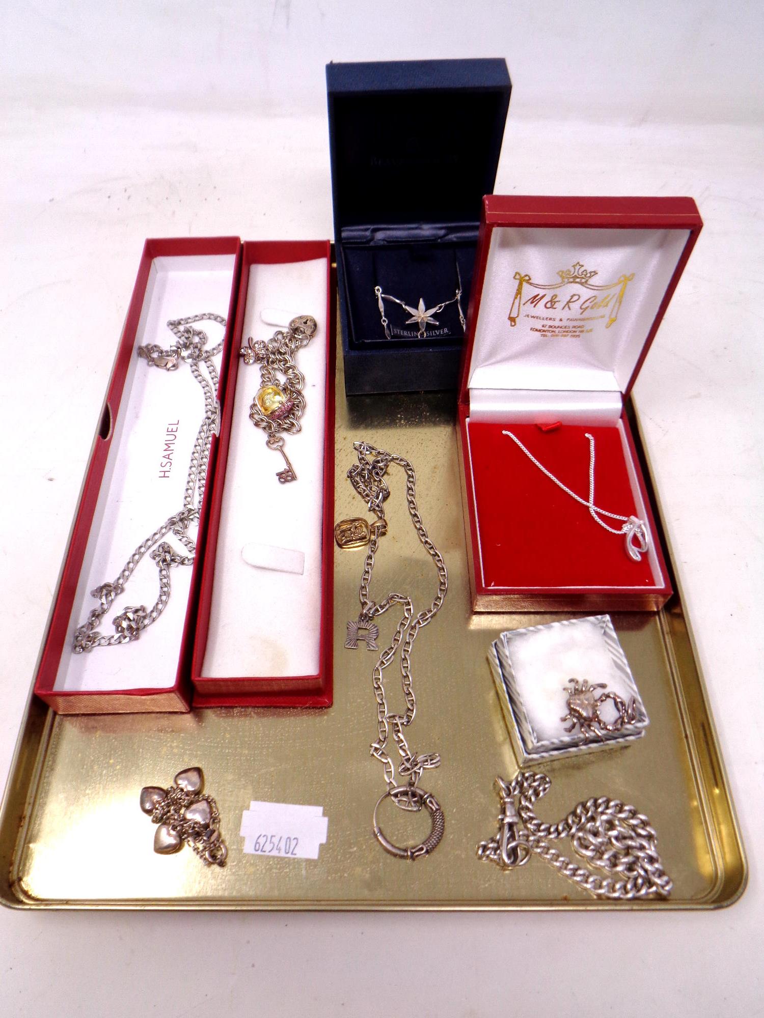 A tray of silver jewellery, curb link chain, charm bracelet, necklace, pendant etc.
