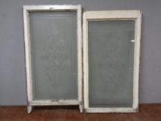 A pair of etched antique windows