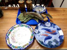 A painted Mexican charger, another charger and a tray of fish ornaments,