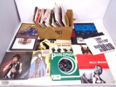 A box of 45 rpm singles including The Beatles, Queen,