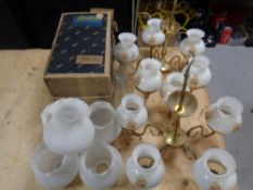 Two brass light fittings with glass shades, five further opaque glass shades,