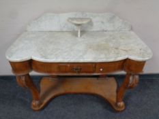 A Victorian mahogany shaped front marble topped wash stand fitted a drawer