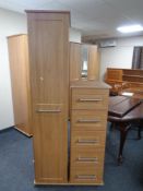 A contemporary wood effect sentry door wardrobe together with similar five drawer chest