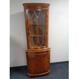 An inlaid yew wood corner cabinet