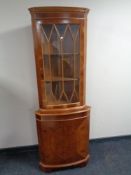 An inlaid yew wood corner cabinet