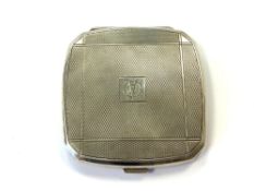 An Art Deco silver compact with engine turned decoration