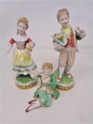 A pair of German porcelain figures of a boy and girl,