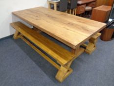 A contemporary oak refectory kitchen table together with a pair of reclaimed pine benches.