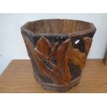 A carved hardwood log bucket