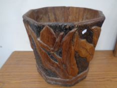 A carved hardwood log bucket