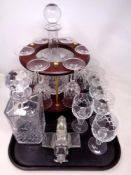 A tray of six wine glasses and decanter on wooden stand, glass cruet in the form of a plane (af),