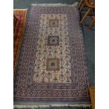 An Afghan rug on blue ground,