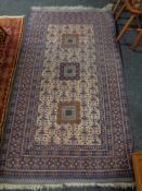 An Afghan rug on blue ground,