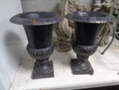A pair of cast iron garden planters,
