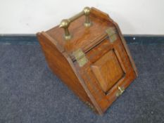 A 19th century oak coal receiver with brass handle and fittings