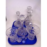 A tray of four cut glass decanters with stoppers,
