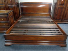 A mahogany effect 6' bed frame