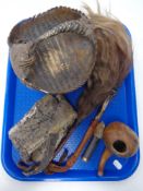 A tray of snake skin, armadillo shell basket,