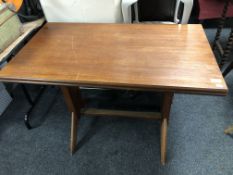 A mid 20th century teak rise and fall refectory table