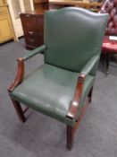 A Gainsborough style mahogany desk chair upholstered in a green studded leather
