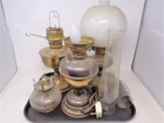 Four assorted oil lamps,
