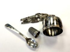 An Arabic silver and niello napkin ring, a coffee spoon,