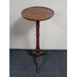 A mahogany torchere together with a two-tier telephone table fitted a drawer