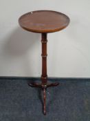 A mahogany torchere together with a two-tier telephone table fitted a drawer